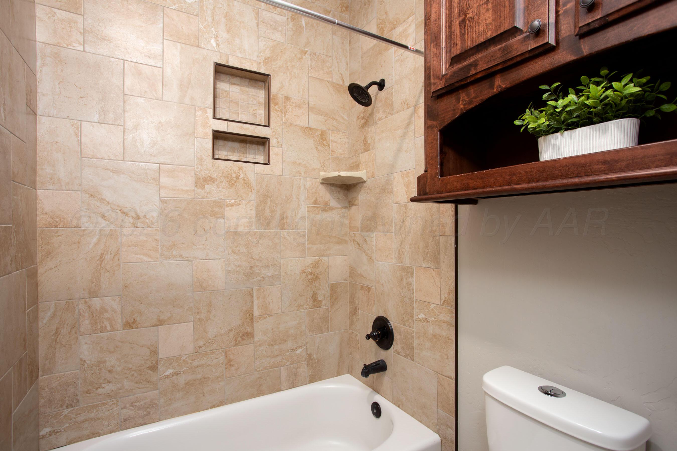 9551 Yesterday Lane Amarillo, TX 79119 - Photo 34 of 53 a bathroom with a bathtub and shower