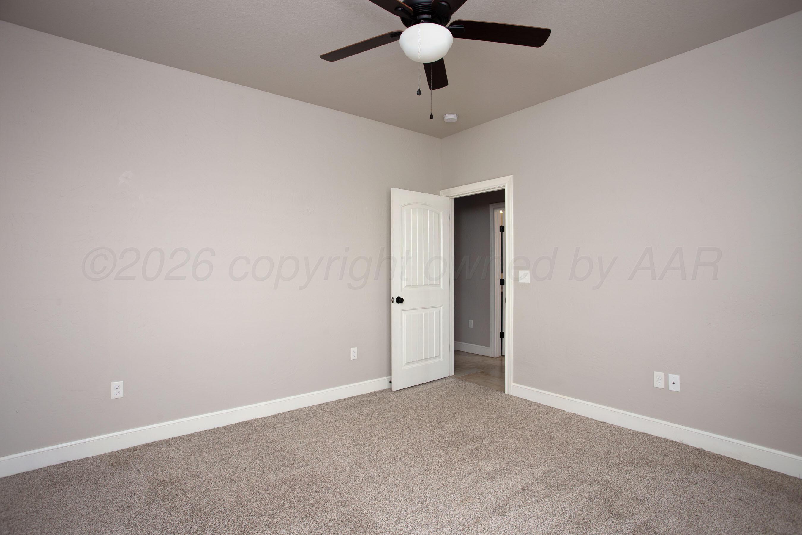 9551 Yesterday Lane Amarillo, TX 79119 - Photo 35 of 53 an empty room with a ceiling fan and a window