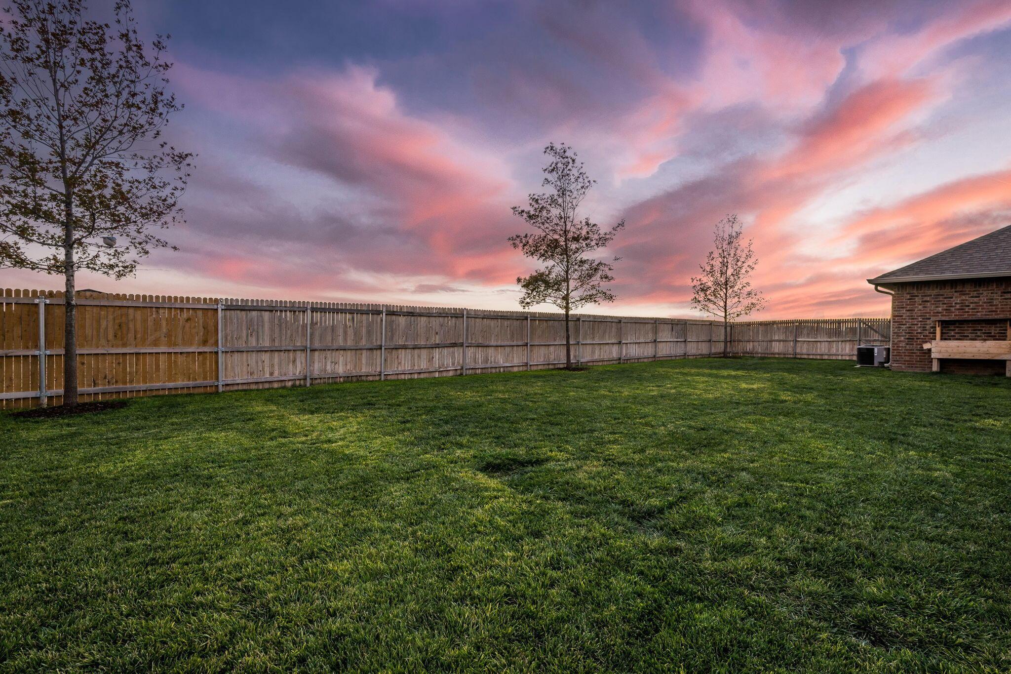 9551 Yesterday Lane Amarillo, TX 79119 - Photo 40 of 53 a view of a backyard with grass & fence