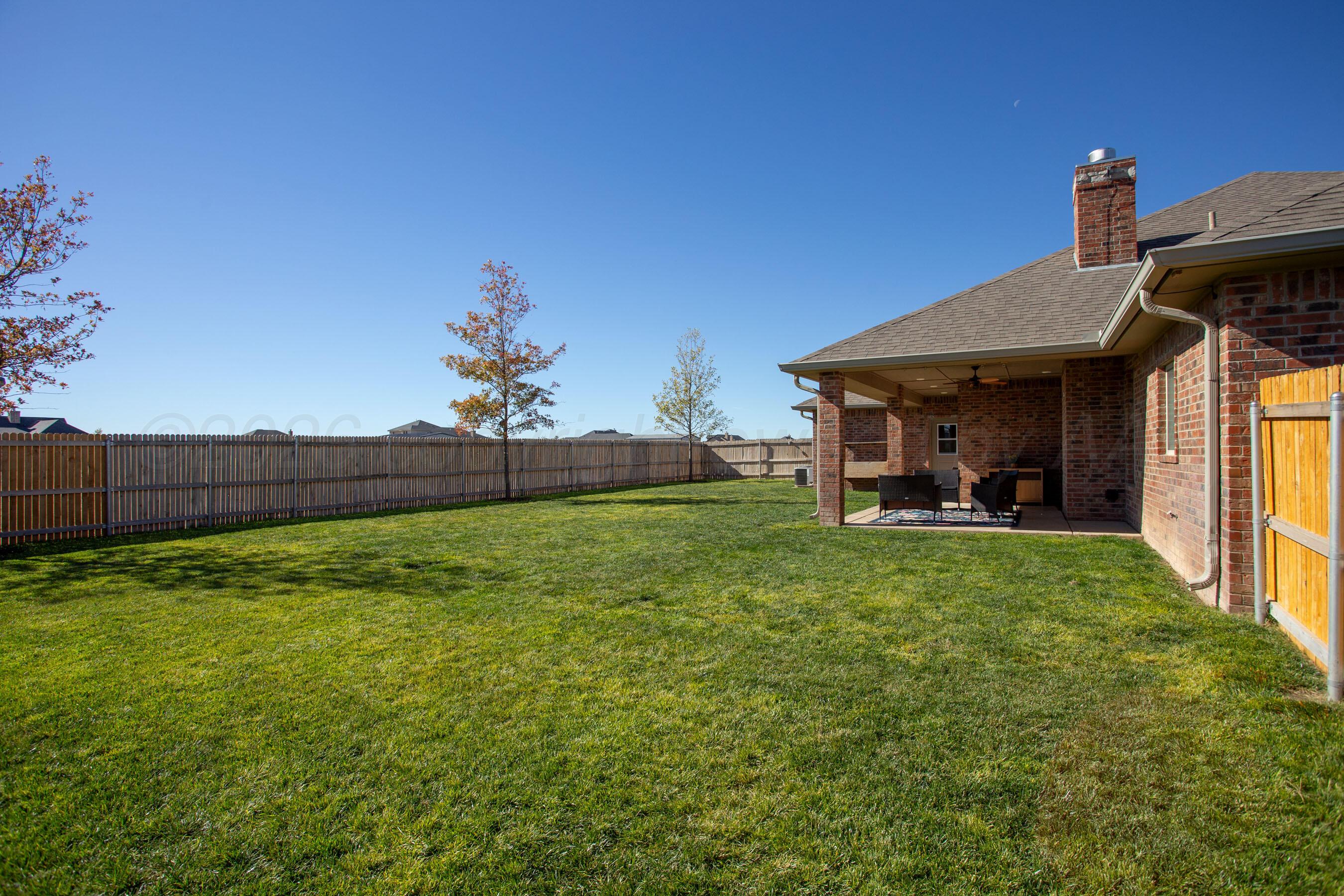 9551 Yesterday Lane Amarillo, TX 79119 - Photo 43 of 53 a view of a house with backyard and a garden