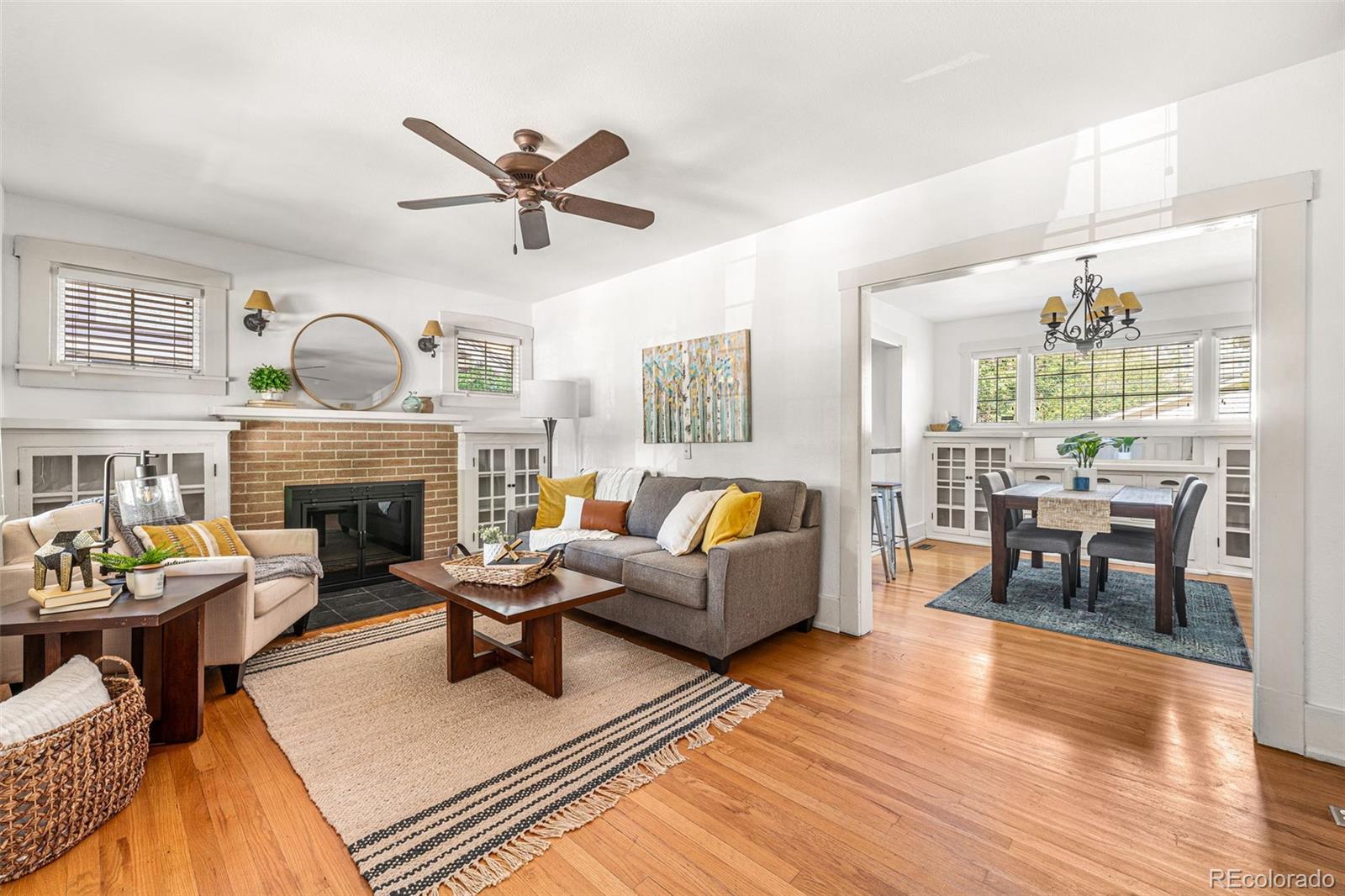 a living room with furniture fireplace and wooden floor