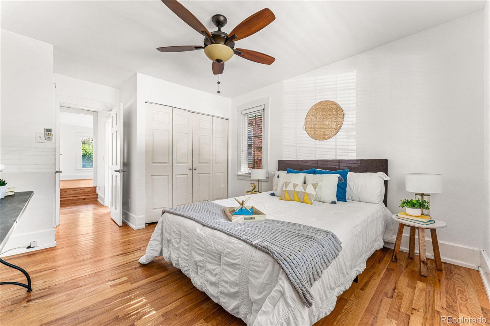 954 Jackson Street Denver, CO 80206 - Photo 13 of 37 a bedroom with a bed and a chandelier