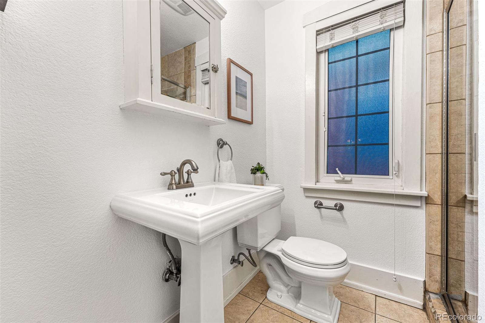954 Jackson Street Denver, CO 80206 - Photo 16 of 37 a bathroom with a toilet sink and mirror