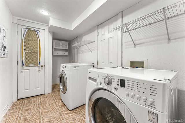 a view of washer and dryer with kitchen in the background