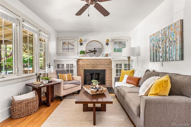 a living room with furniture fireplace and window