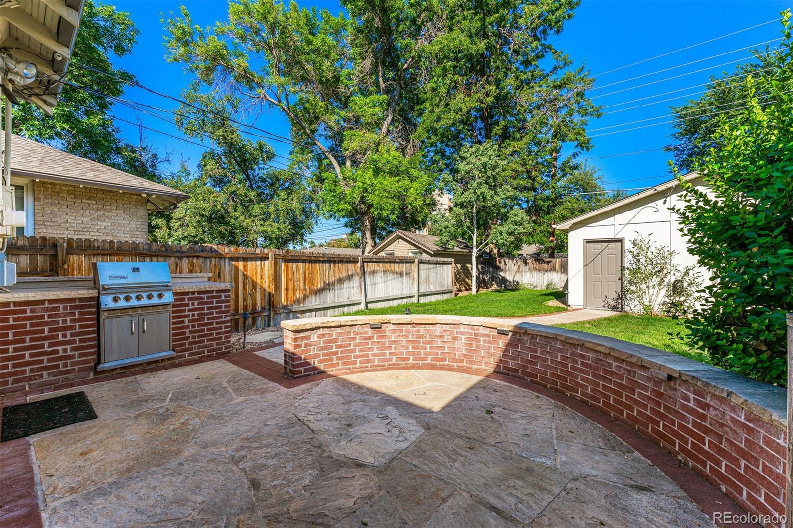 954 Jackson Street Denver, CO 80206 - Photo 23 of 37 a view of a backyard with a tree