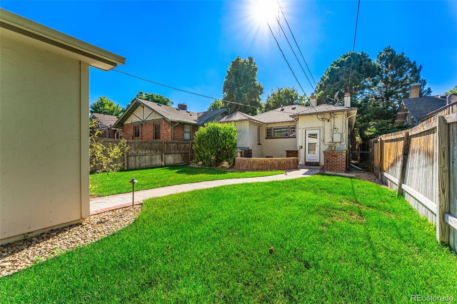 954 Jackson Street Denver, CO 80206 - Photo 25 of 37 a view of a house with a yard and green space