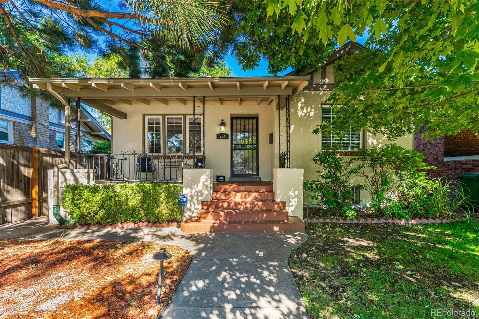 954 Jackson Street Denver, CO 80206 - Photo 5 of 37 a front view of a house with a yard