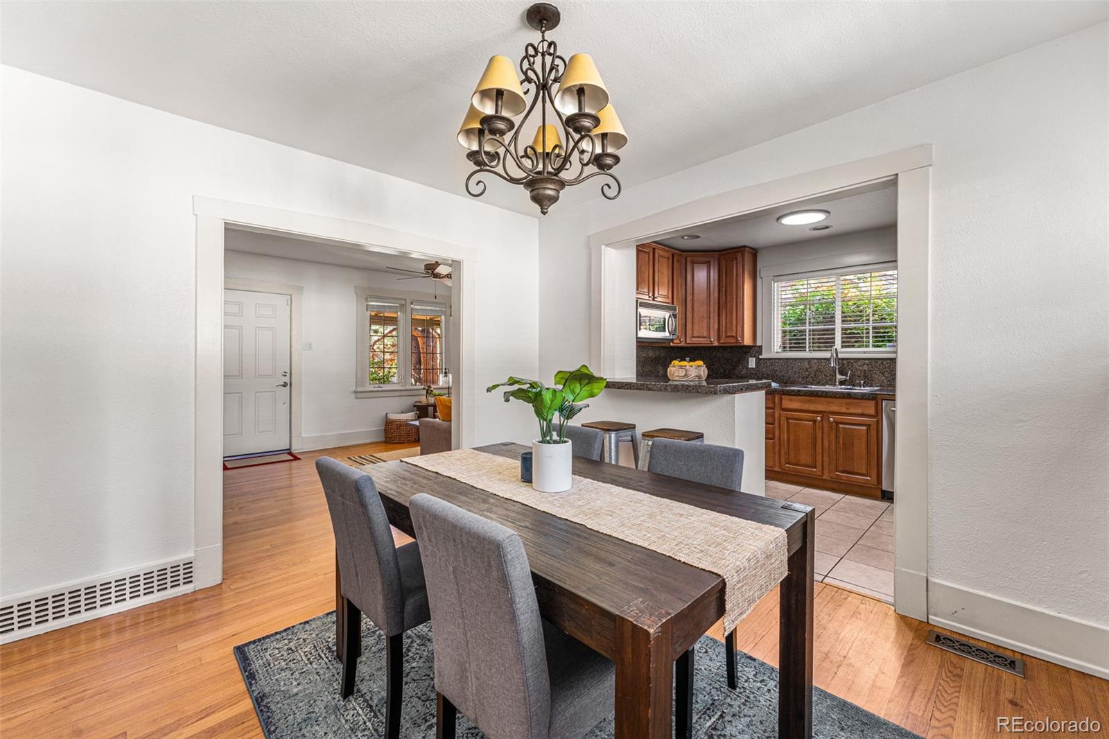 954 Jackson Street Denver, CO 80206 - Photo 8 of 37 a view of a dining room with furniture wooden floor and chandelier