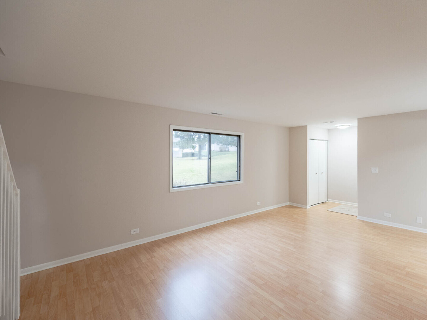 624 Breakers Point, Unit 624 Schaumburg, IL 60194 - Photo 2 of 13 an empty room with wooden floor and windows