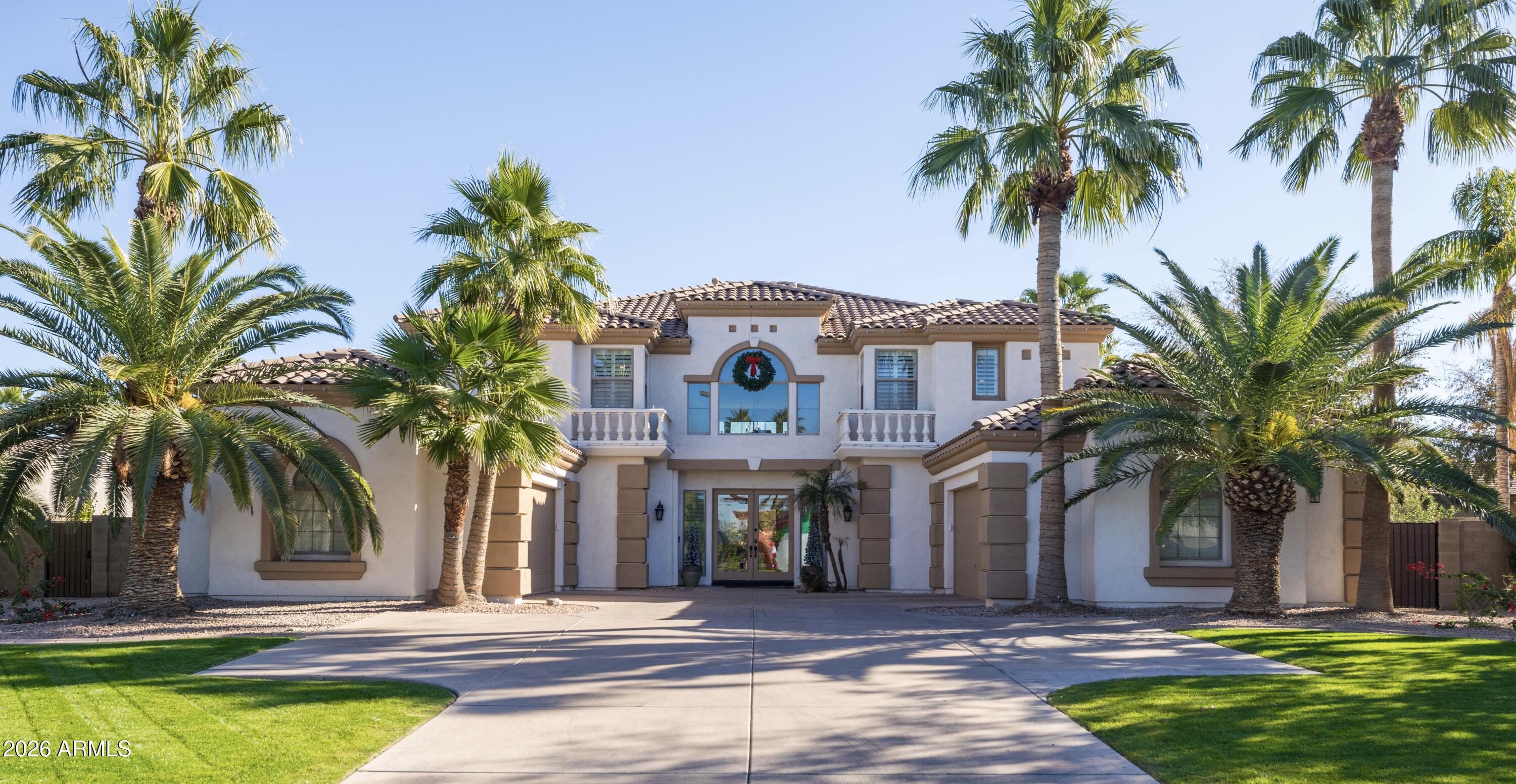 a front view of house with yard and palm tree