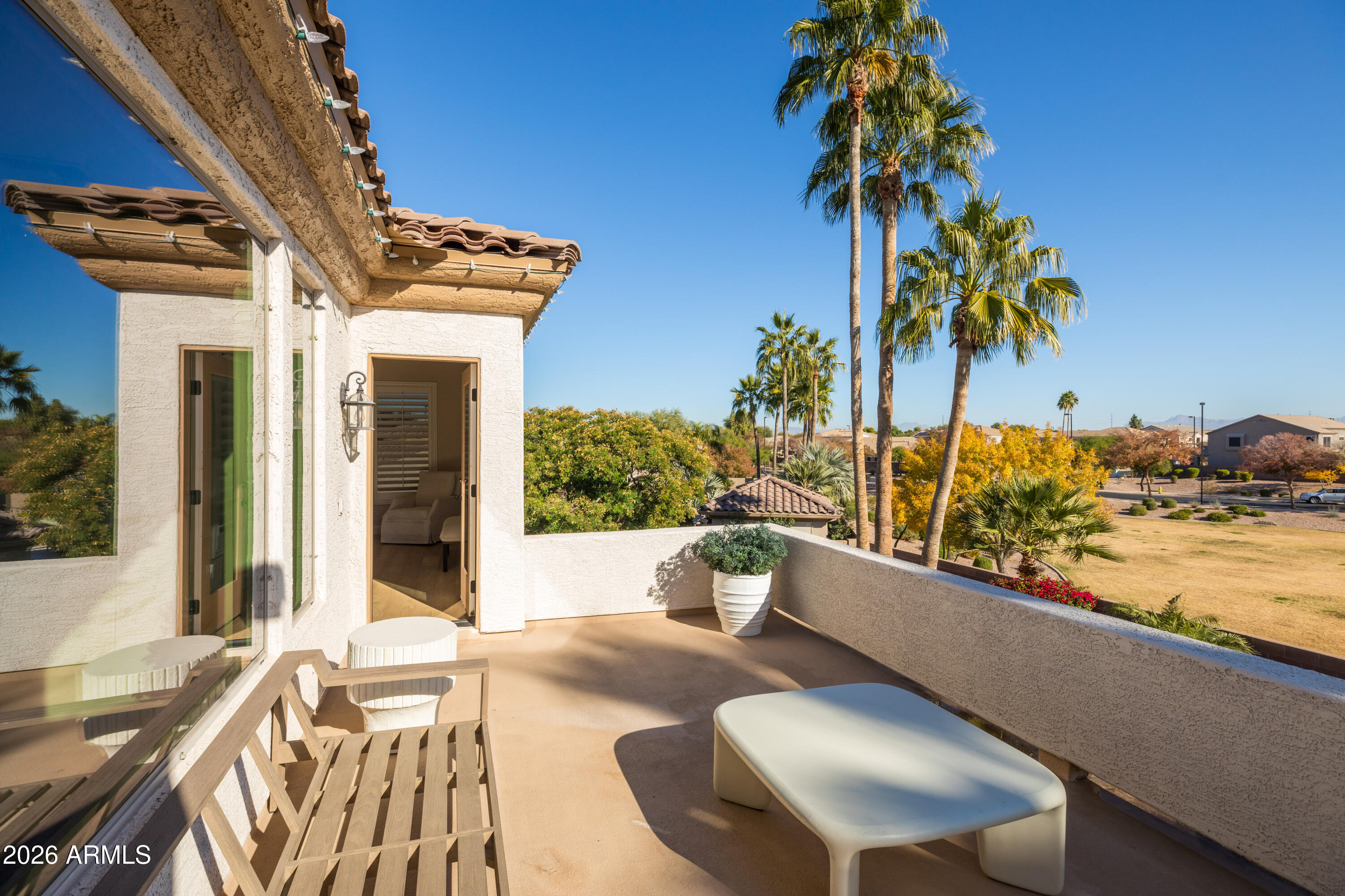 2517 South Constellation Way Gilbert, AZ 85295 - Photo 24 of 47 a view of a patio with couches and table and chairs under an umbrella