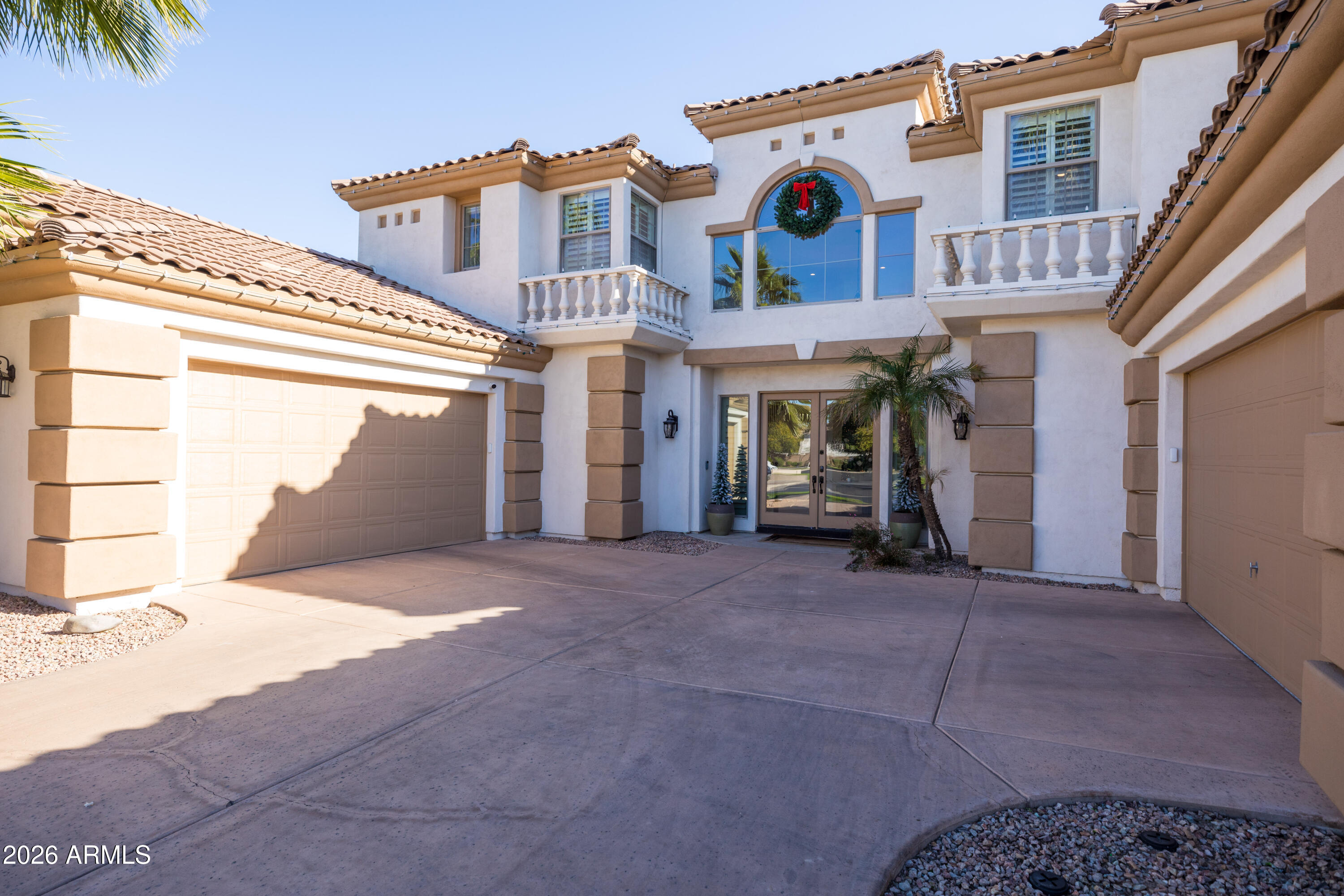 2517 South Constellation Way Gilbert, AZ 85295 - Photo 3 of 47 a view of a white house with large windows and a tree