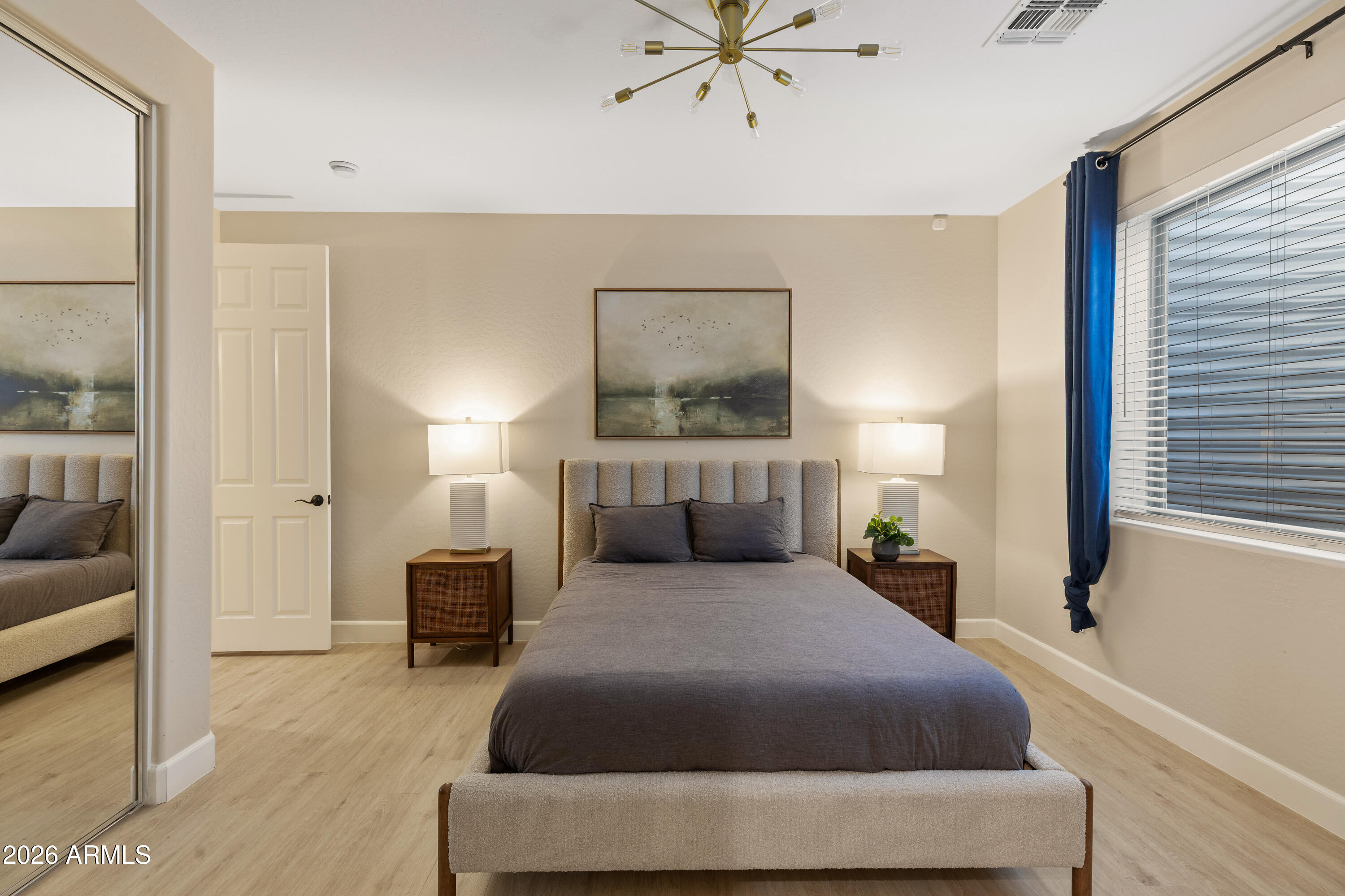 2517 South Constellation Way Gilbert, AZ 85295 - Photo 38 of 47 a spacious bedroom with a bed a couch and a window