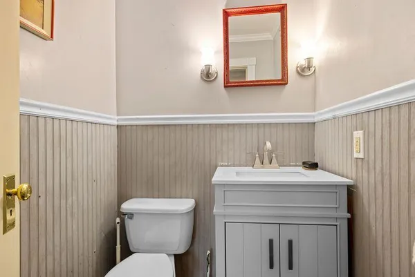 a bathroom with a sink a toilet and mirror