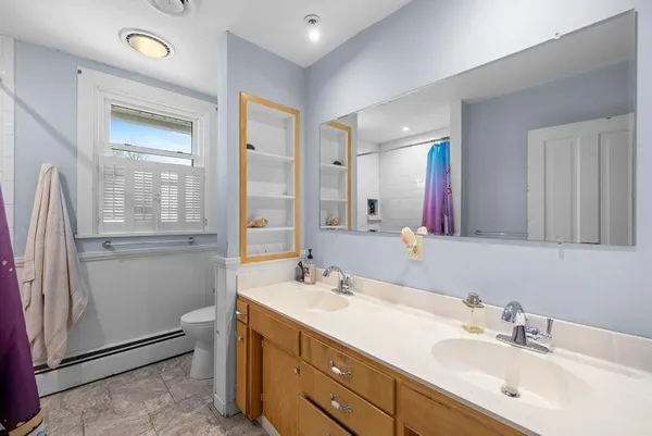 a bathroom with double vanity sink and a mirror