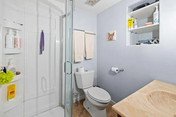 a bathroom with a toilet and a shower