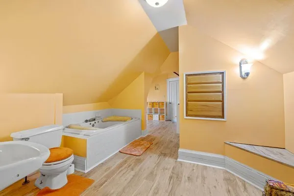 a spacious bathroom with a granite countertop sink and a mirror