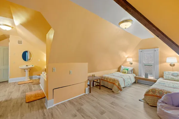 a bed room with two bed and a large mirror