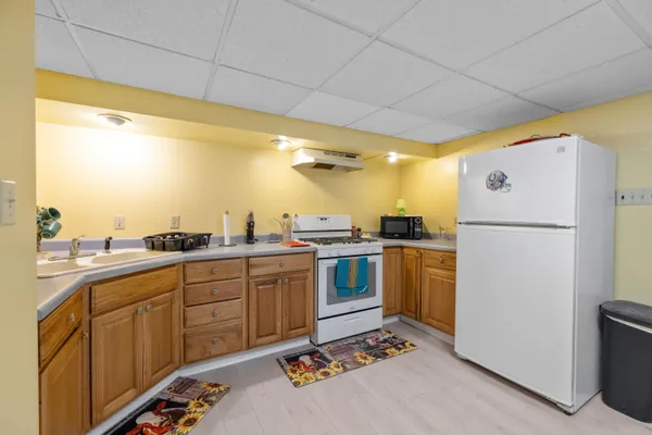 a kitchen with refrigerator and cabinets