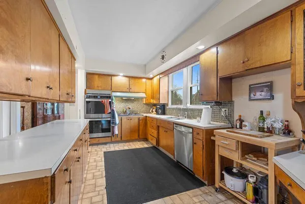 a kitchen with stainless steel appliances a stove a sink and a refrigerator
