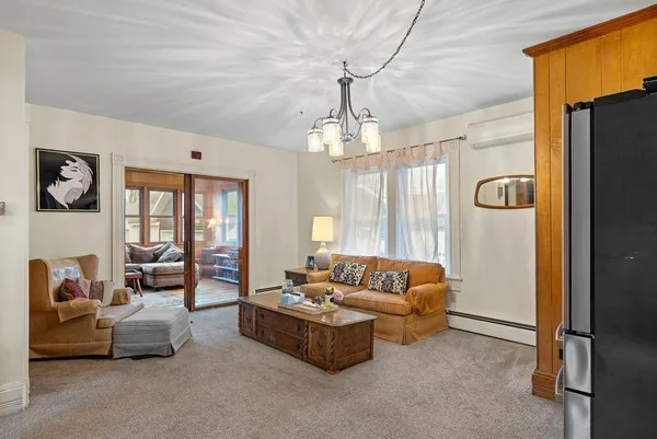 a living room with furniture and a chandelier