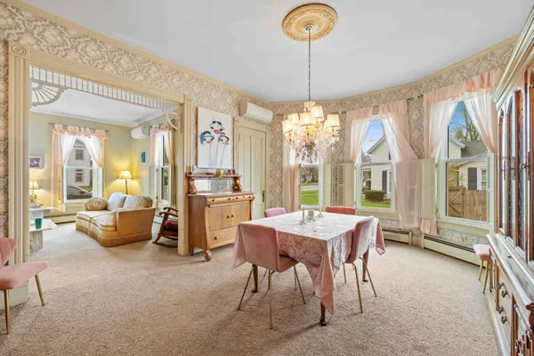 a view of a dining room with furniture window and wooden floor
