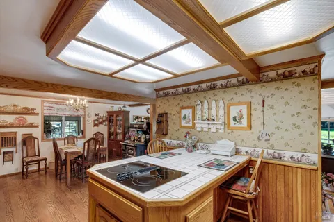 a dining room with furniture a chandelier and wooden floor