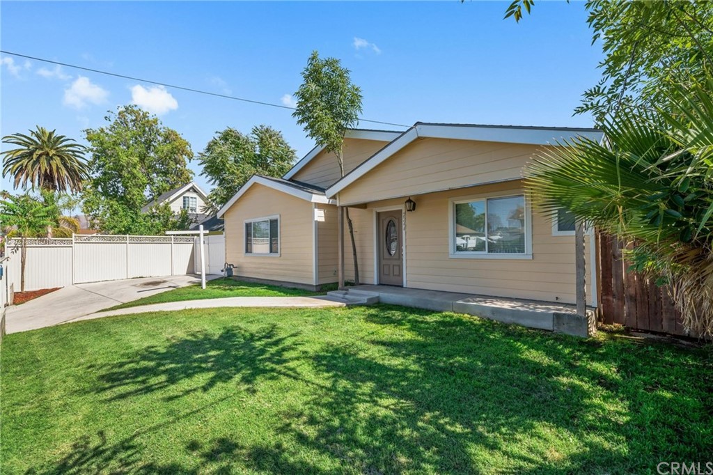 2244 4th Street Riverside, CA 92507 - Photo 1 of 1 a backyard of a house with potted plants and large tree