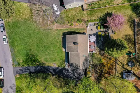 an aerial view of a house with a yard