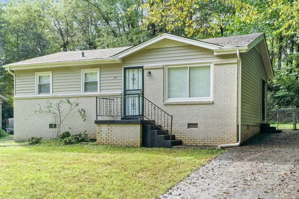 a front view of a house with a garden