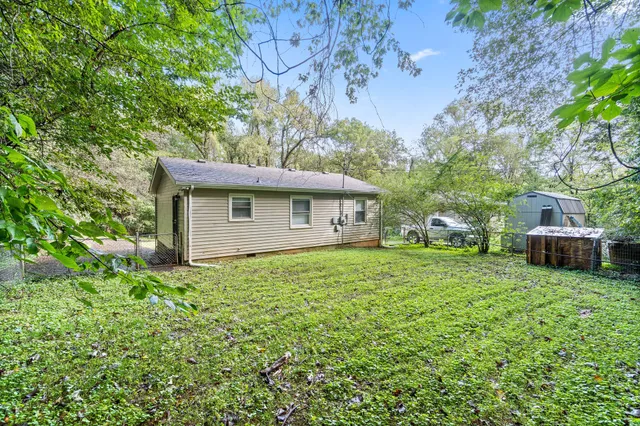 a view of a house with a backyard