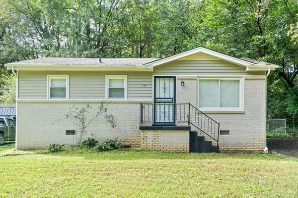 a front view of a house with a garden