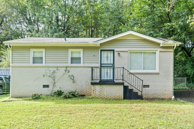 a front view of a house with a garden