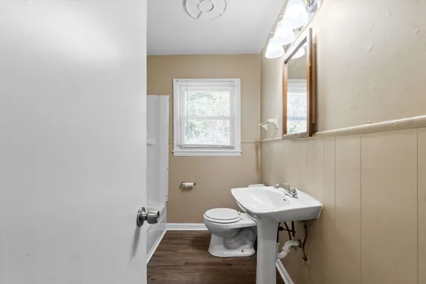 a bathroom with a sink toilet and a mirror