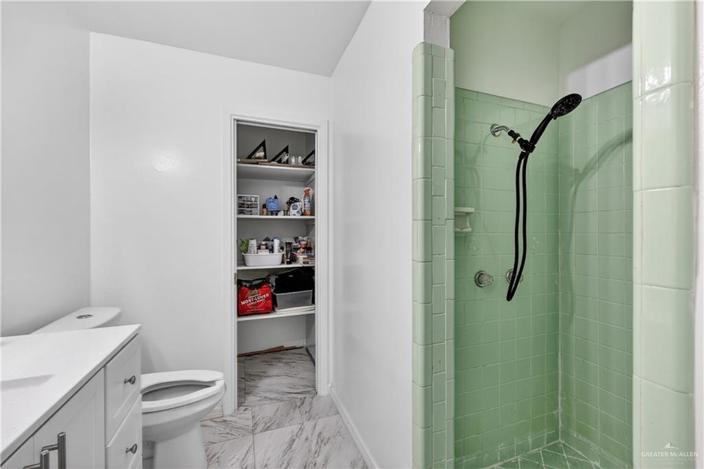616 5th Street Weslaco, TX 78596 - Photo 28 of 33 a bathroom with a toilet and a shower