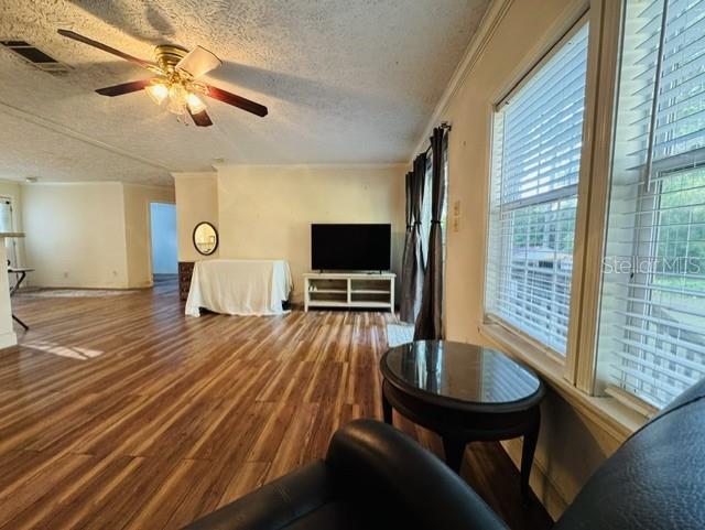 11817 Southwest 58th Street Webster, FL 33597 - Photo 2 of 46 a living room with furniture and a flat screen tv