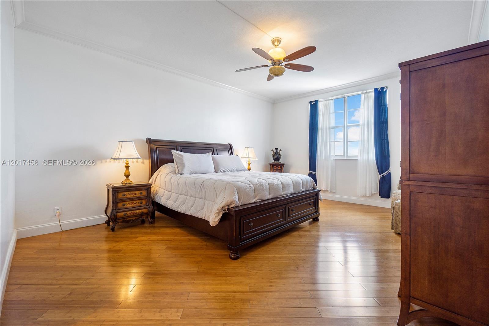2851 South Ocean Boulevard, Unit 7U Boca Raton, FL 33432 - Photo 12 of 15 a bedroom with a bed and wooden floor