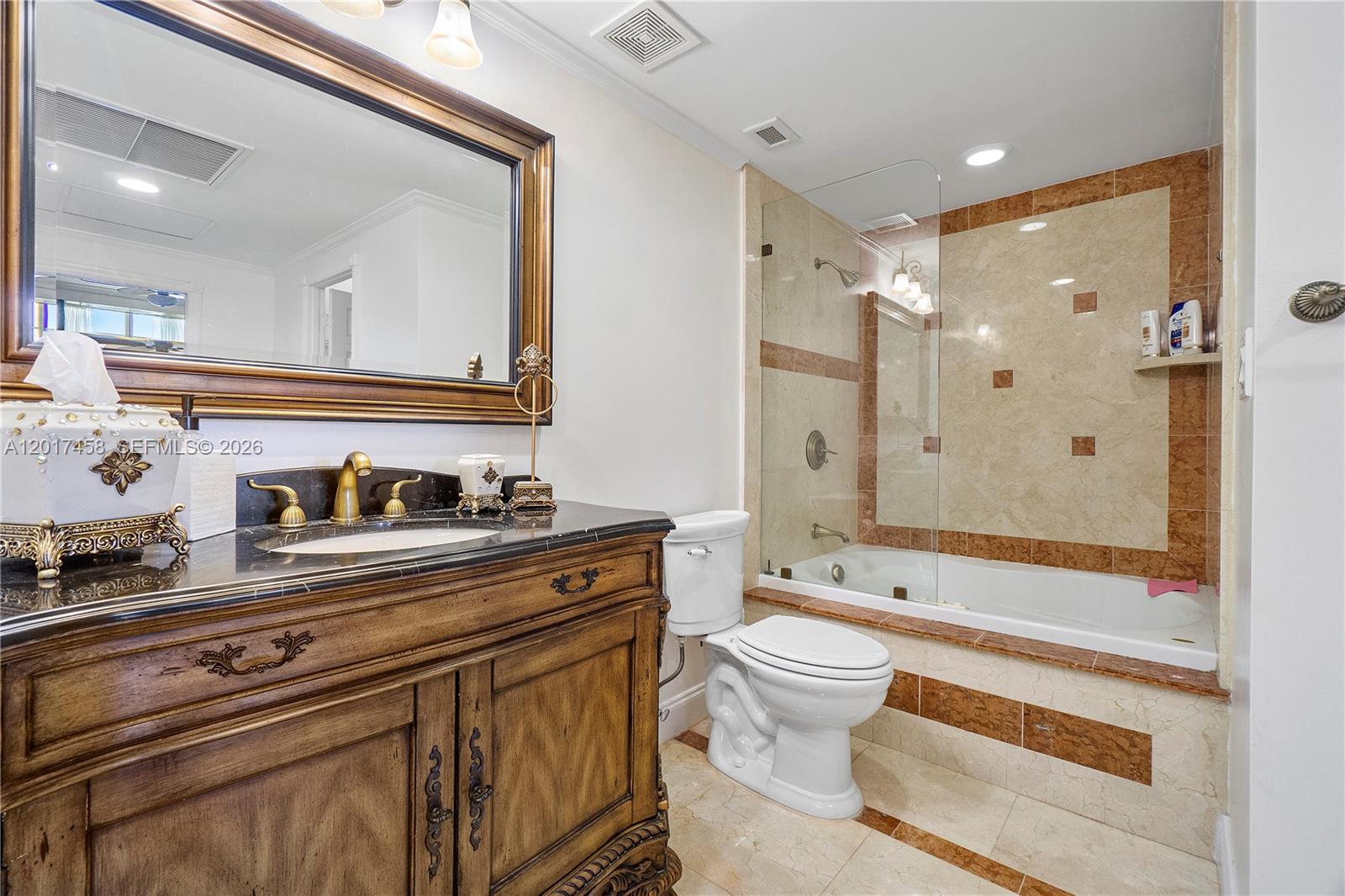 2851 South Ocean Boulevard, Unit 7U Boca Raton, FL 33432 - Photo 15 of 15 a bathroom with a granite countertop sink a toilet a mirror and shower
