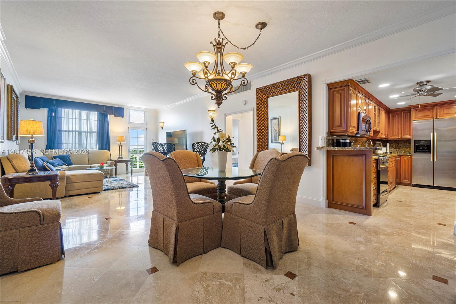 2851 South Ocean Boulevard, Unit 7U Boca Raton, FL 33432 - Photo 6 of 15 a dining room with wooden floor a chandelier a wooden table and chairs