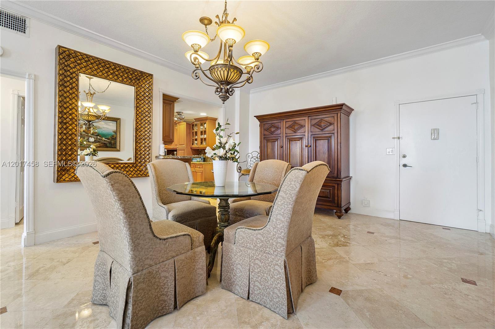 2851 South Ocean Boulevard, Unit 7U Boca Raton, FL 33432 - Photo 7 of 15 a dining room with furniture a chandelier and a rug