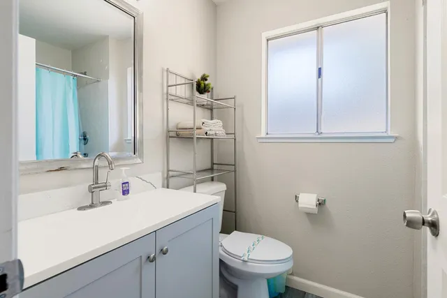 a bathroom with a sink toilet and vanity