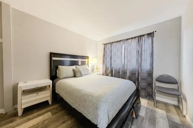 a bedroom with a bed and a window