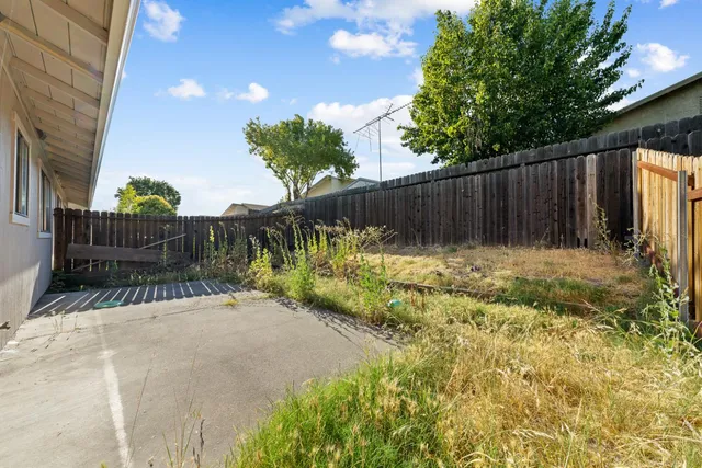 a view of garden with wooden fence