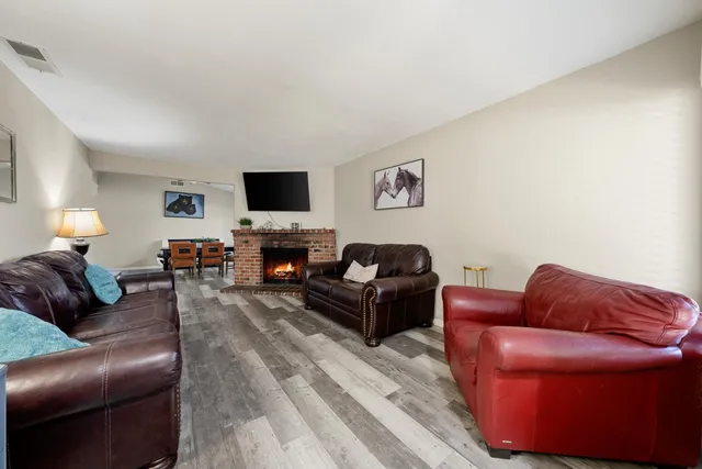 a living room with furniture a flat screen tv and a couch