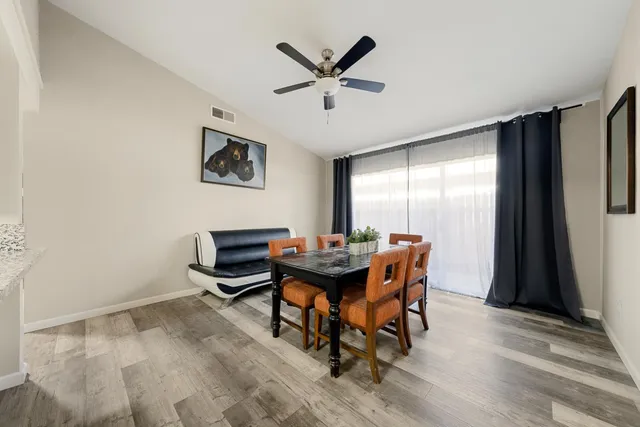 a work room with furniture and window with wooden floor