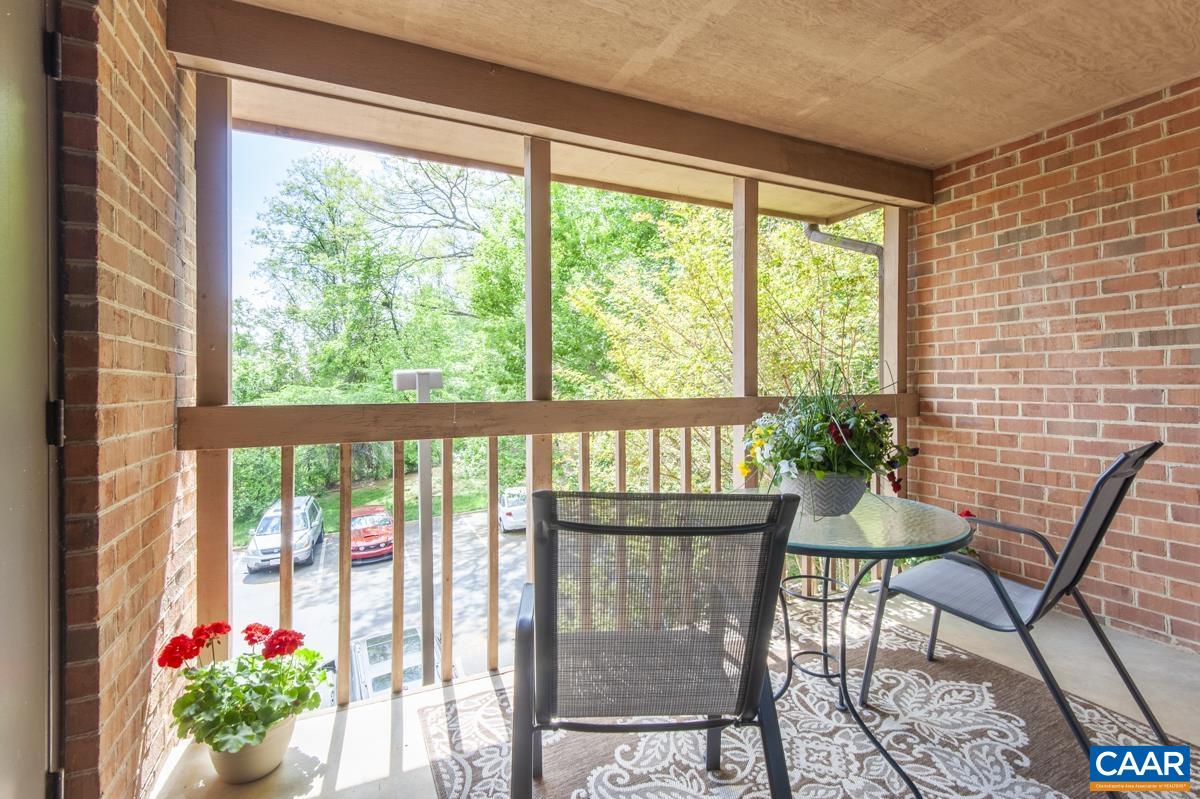 a view of a chairs and table in a balcony