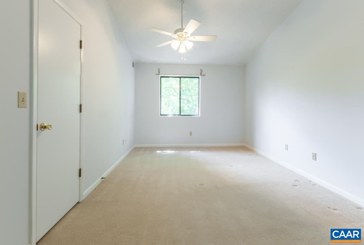 117 Turtle Creek Road, Unit 9 Charlottesville, VA 22901 - Photo 13 of 33 an empty room with a window and a ceiling fan