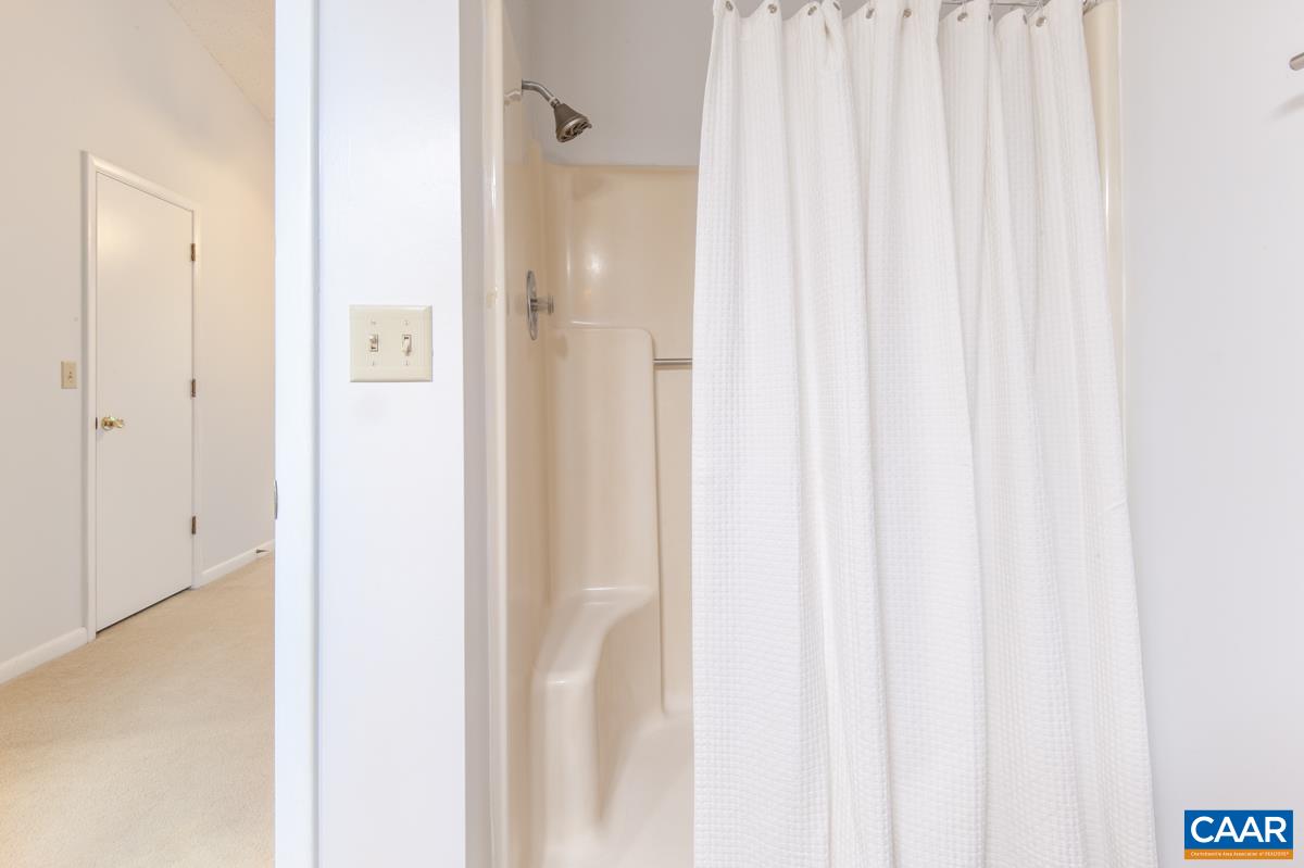 117 Turtle Creek Road, Unit 9 Charlottesville, VA 22901 - Photo 17 of 33 a view of a bathroom with a shower curtain