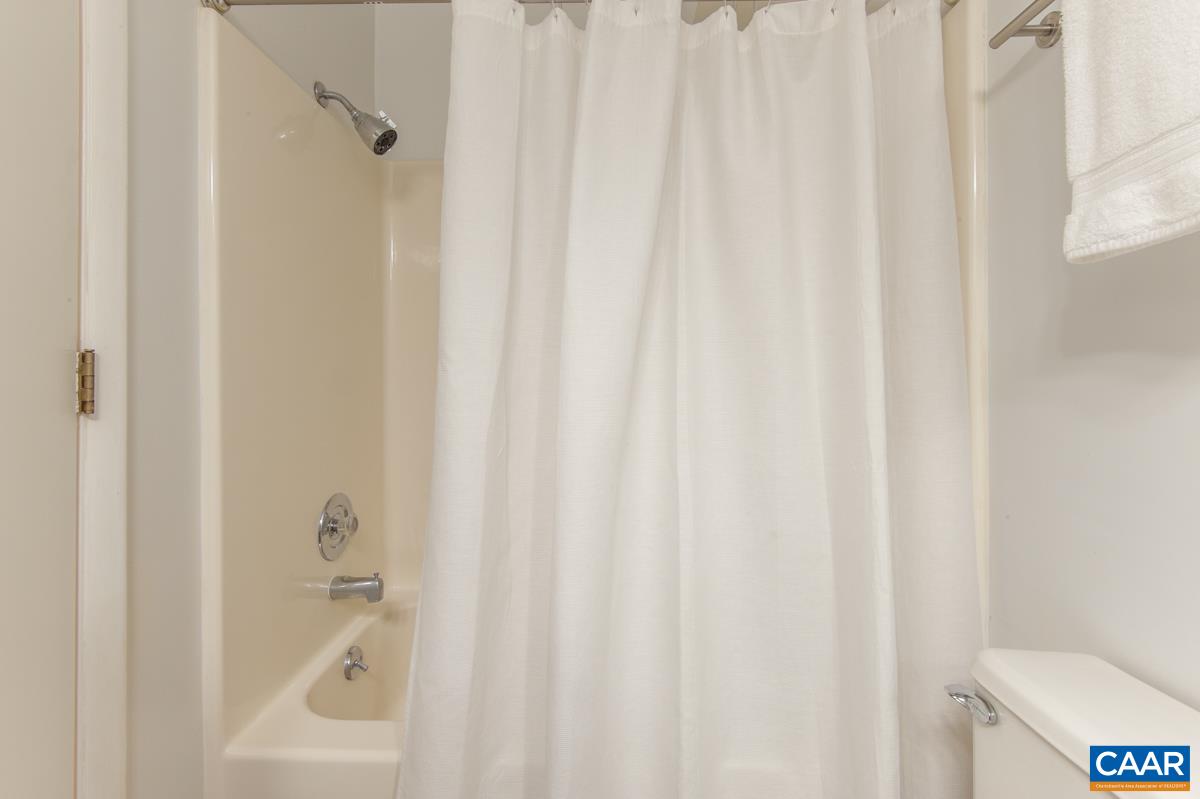 117 Turtle Creek Road, Unit 9 Charlottesville, VA 22901 - Photo 22 of 33 a bathroom with a shower curtain and a toilet